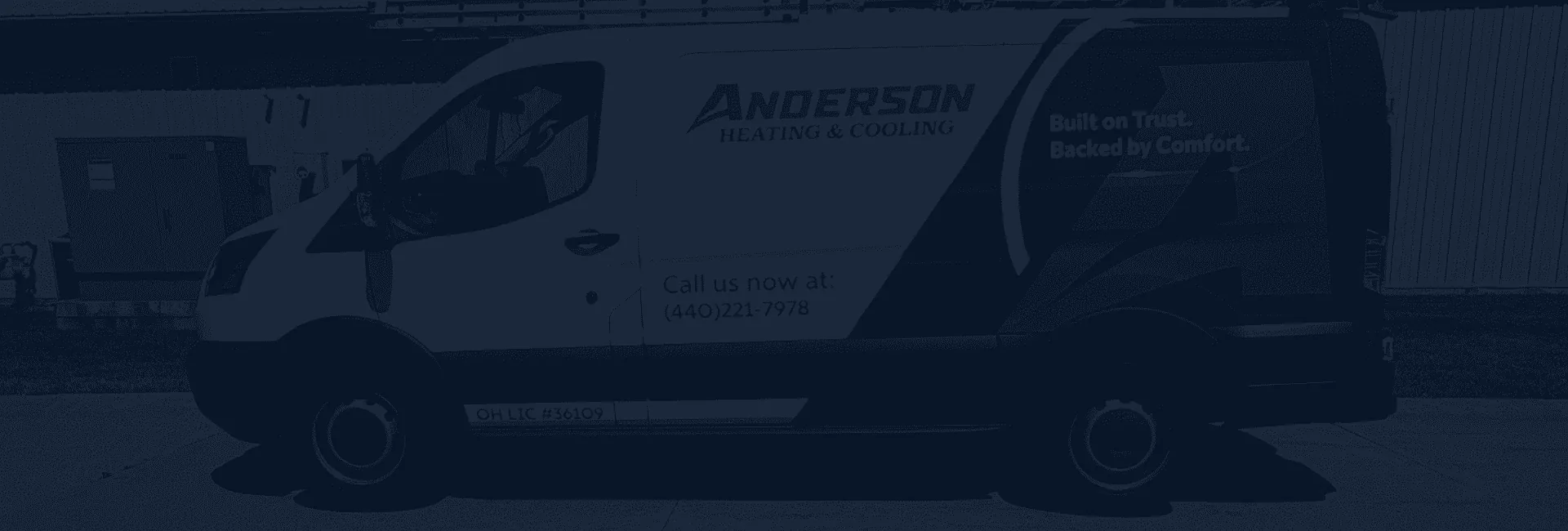 Anderson Heating & Cooling service van parked side on, with the phone number and license number on its door