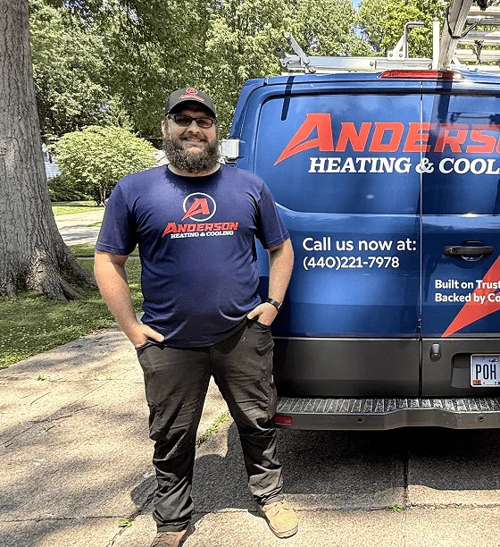 Anderson technician standing beside an Anderson Heating and Cooling service van