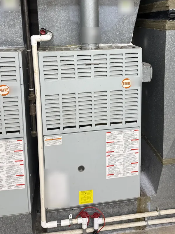Gas furnace with its vent pipe and ductwork during a furnace tune-up in Westlake, OH