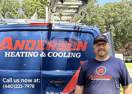 Anderson technician standing beside an Anderson Heating & Cooling service van