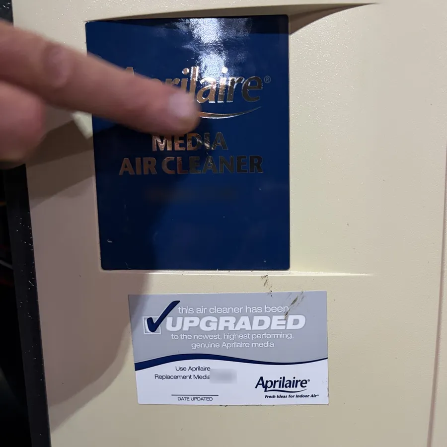AprilAire media air cleaner cabinet with a sticker for its upgraded filter