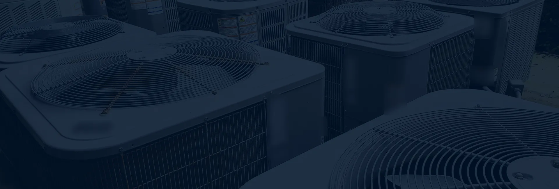 Rows of outdoor air conditioner units with fan grilles on top